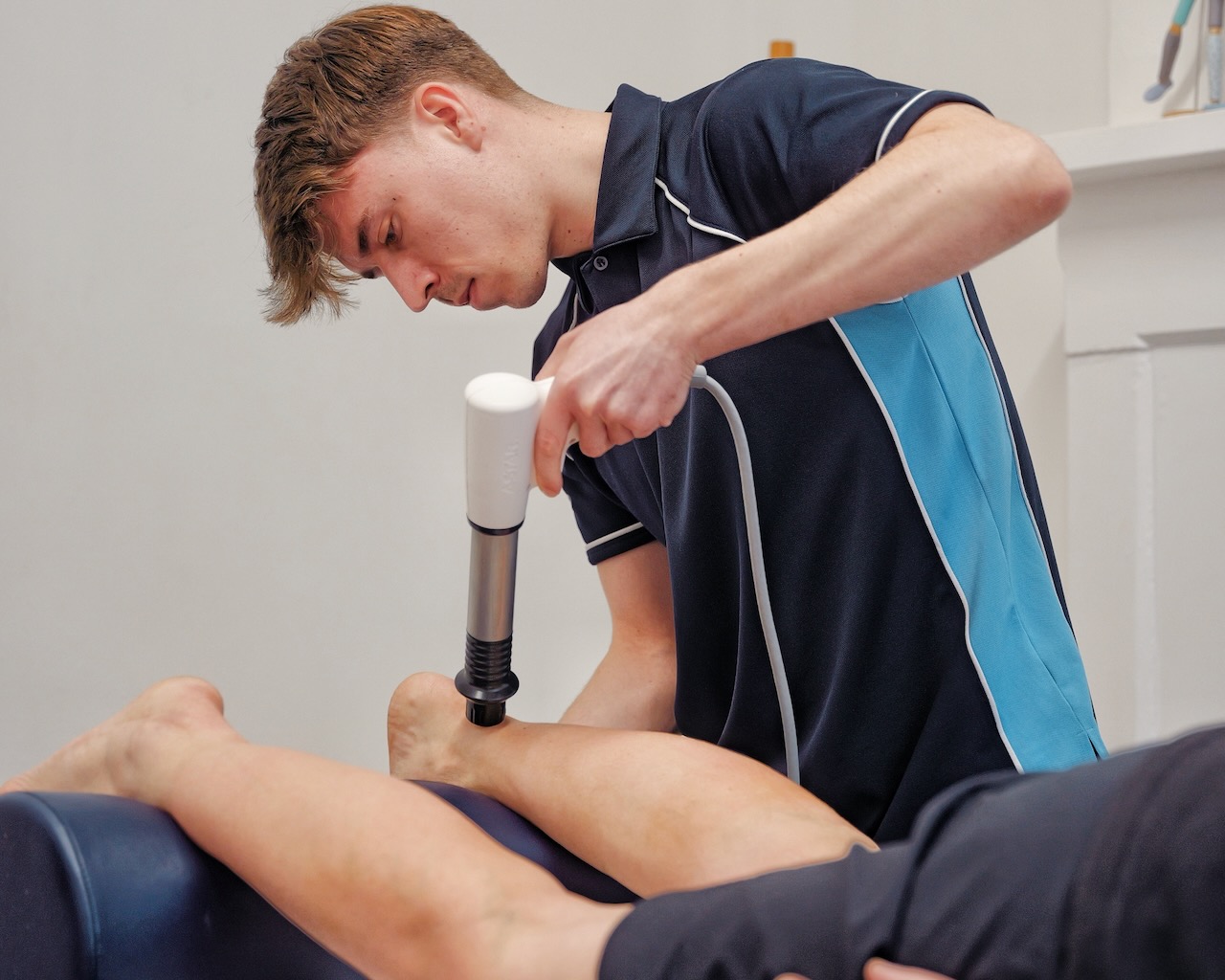 A patent receiving shockwave therapy treatment at Recover Physio